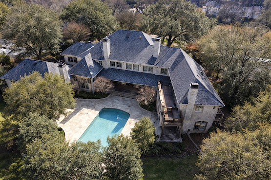 Aerial view of completed residential roof installation on luxury home with pool in Plano, Texas