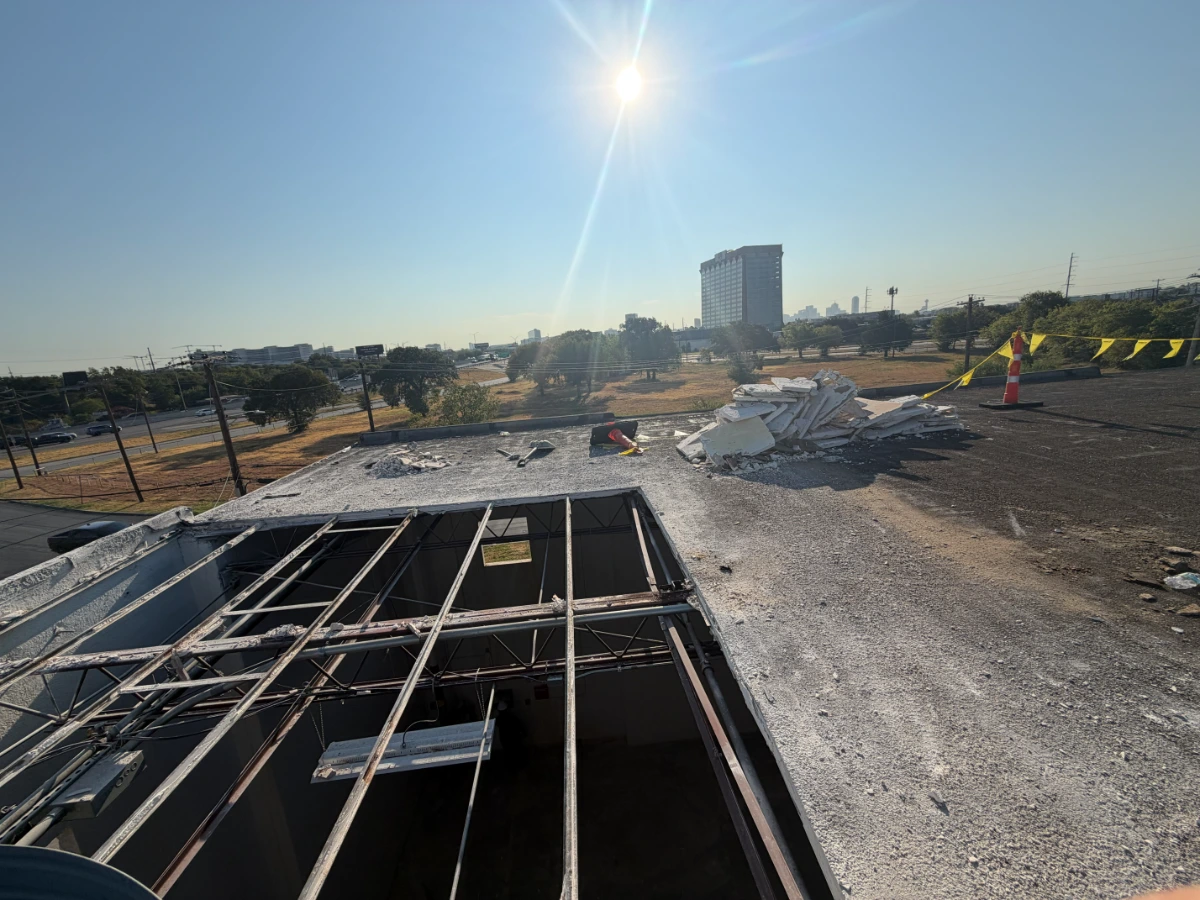 Old gypsum roof deck removed down to the bar joists during a commercial roof replacement near Love Field in Dallas, Dallas County, TX.
