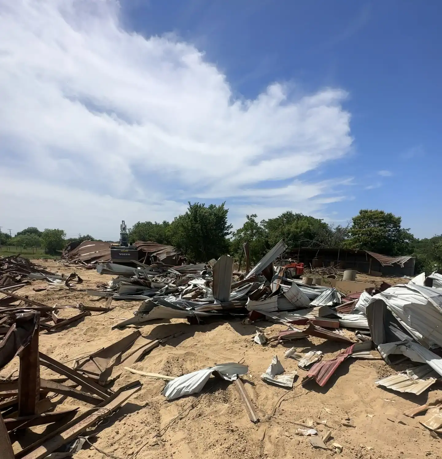 Commercial Demolition Farmers Branch: Wood and metal debris spread across a commercial demolition site before haul-off Wood and metal debris spread across a commercial demolition site before haul-off