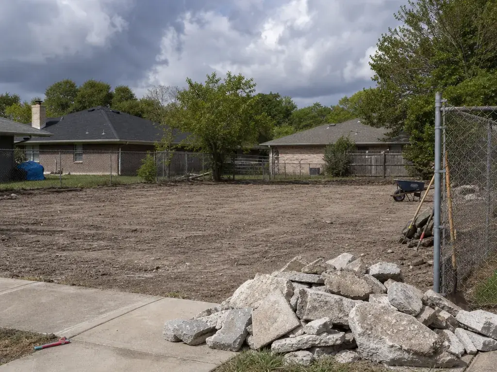 Concrete Removal Farmers Branch: Broken concrete piled by the curb Broken concrete piled by the curb on a cleared lot after slab removal