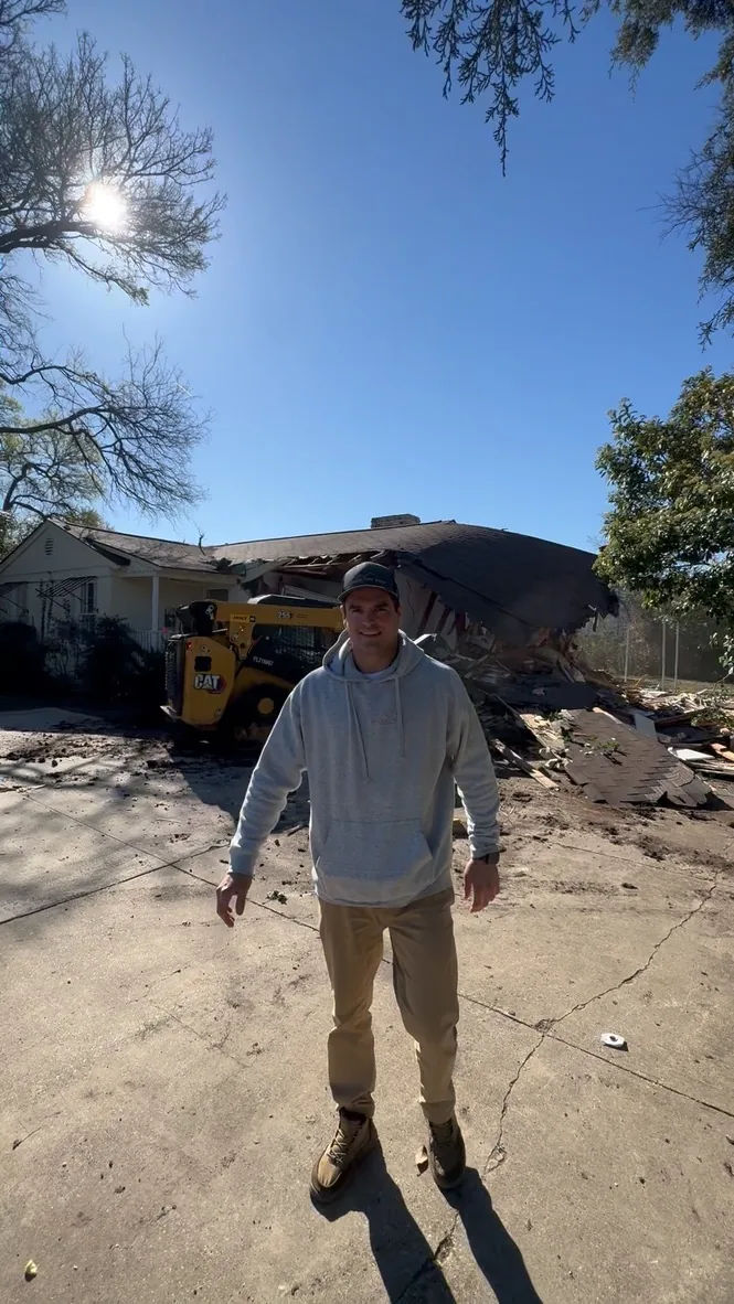 Concrete Removal Farmers Branch: Max Wensinger standing on an old concrete slab with demolition equipment behind him Max Wensinger standing on an old concrete slab with demolition equipment behind him