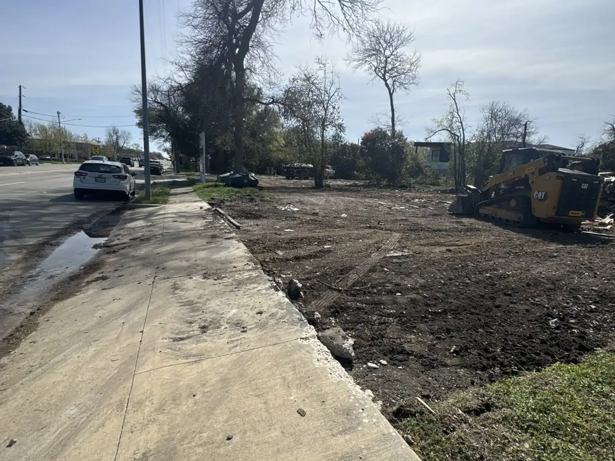 House Demolition Farmers Branch: Cleared lot along the sidewalk Cleared lot along the sidewalk after a teardown and debris haul-off