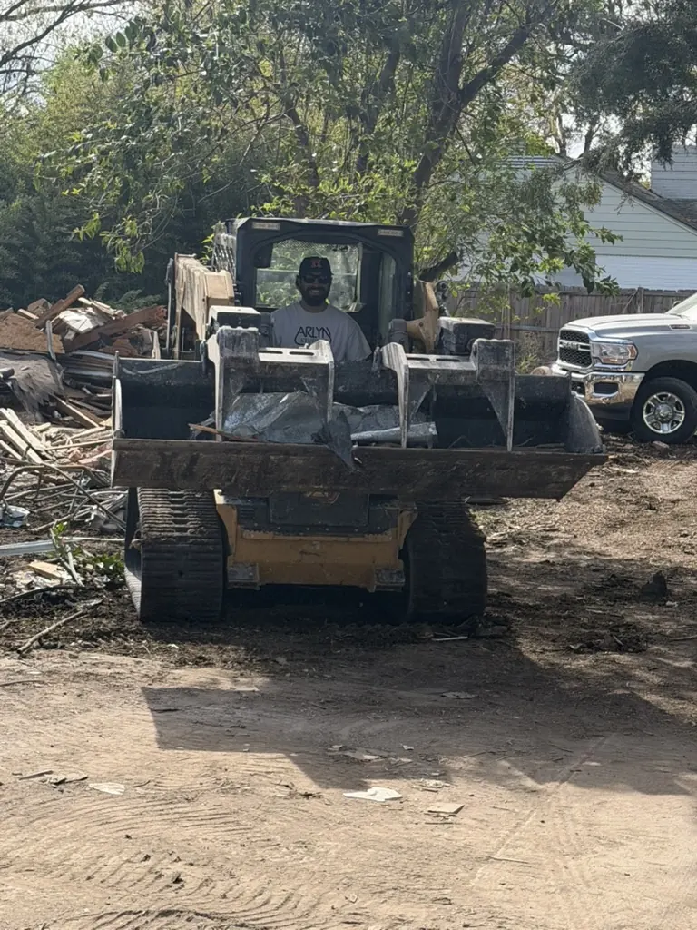 Residential Demolition Dallas: Skid steer and work truck Skid steer and work truck on a residential demolition site in Dallas