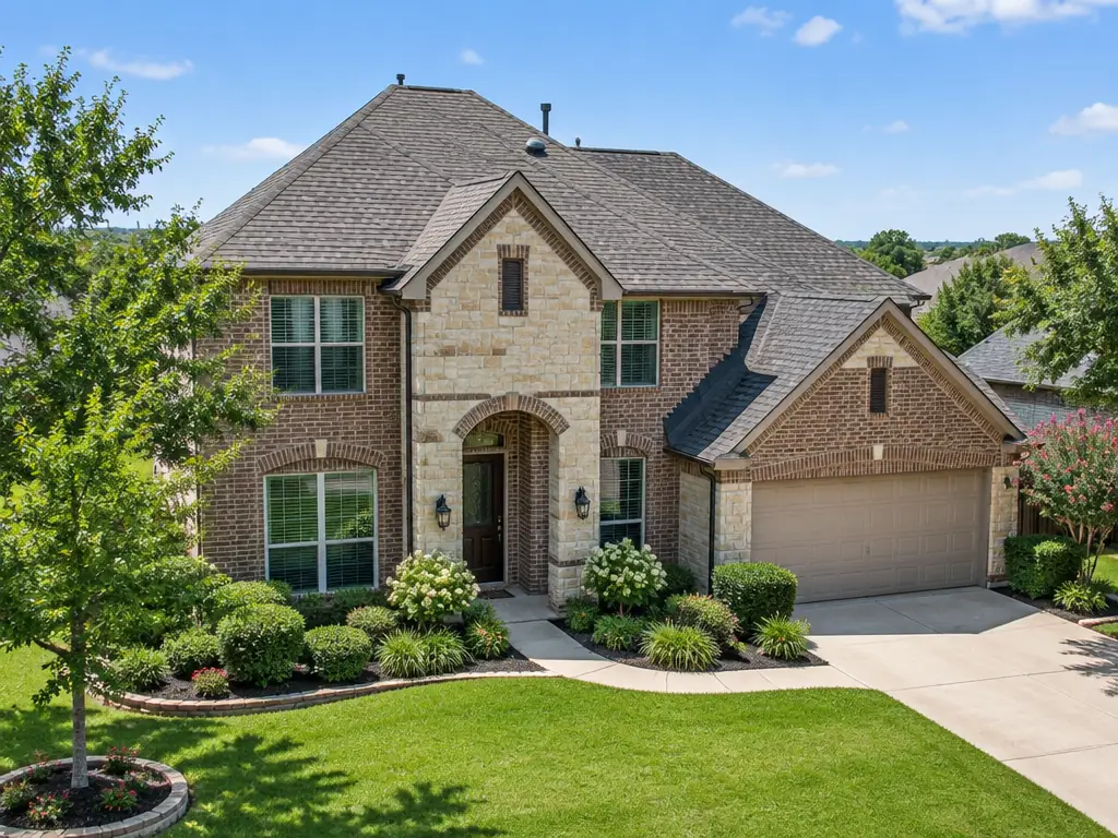 Finished residential shingle roof on a brick and stone home in Carrollton