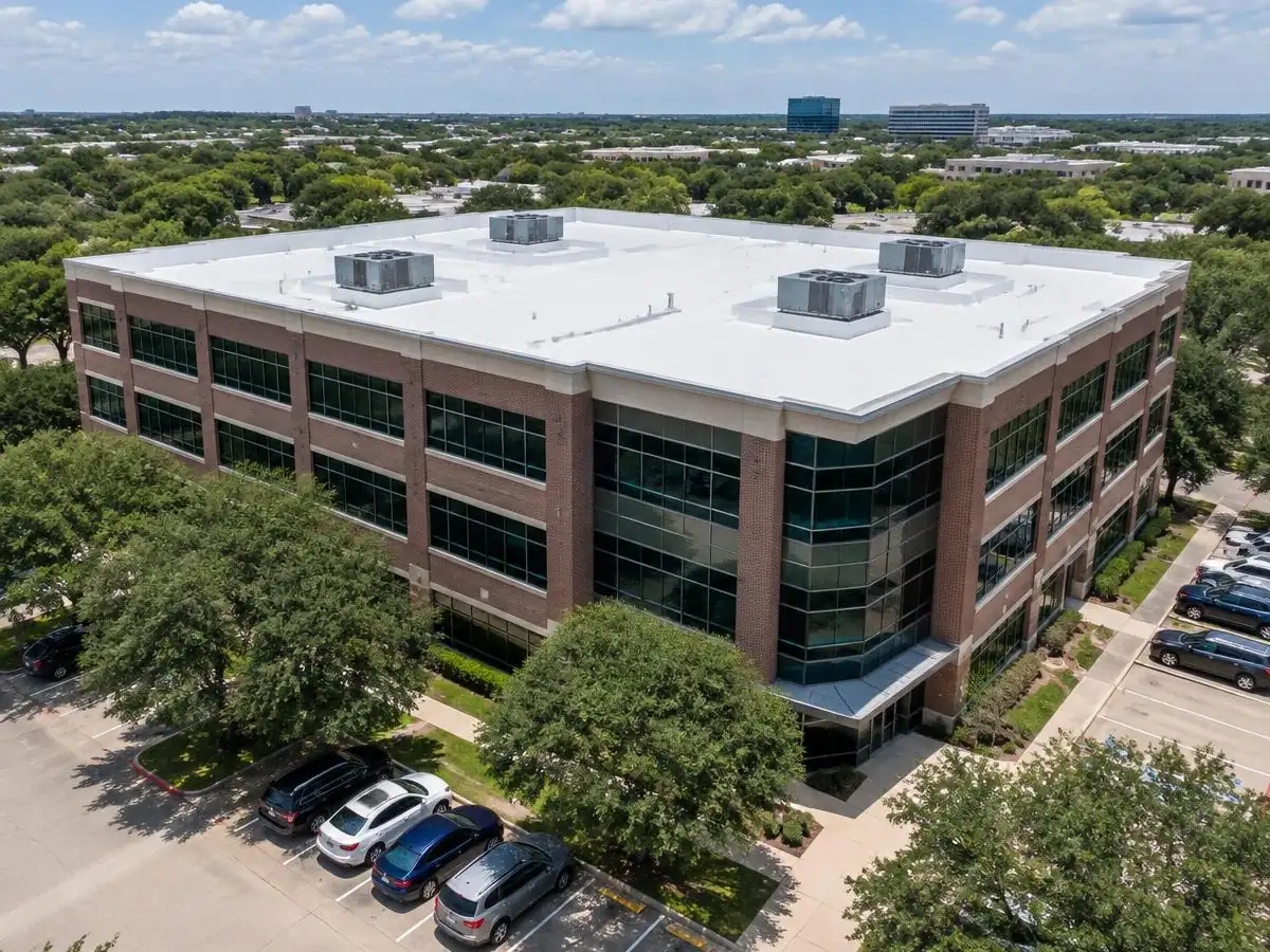 White TPO roof on a mid-rise office building in Addison, TX