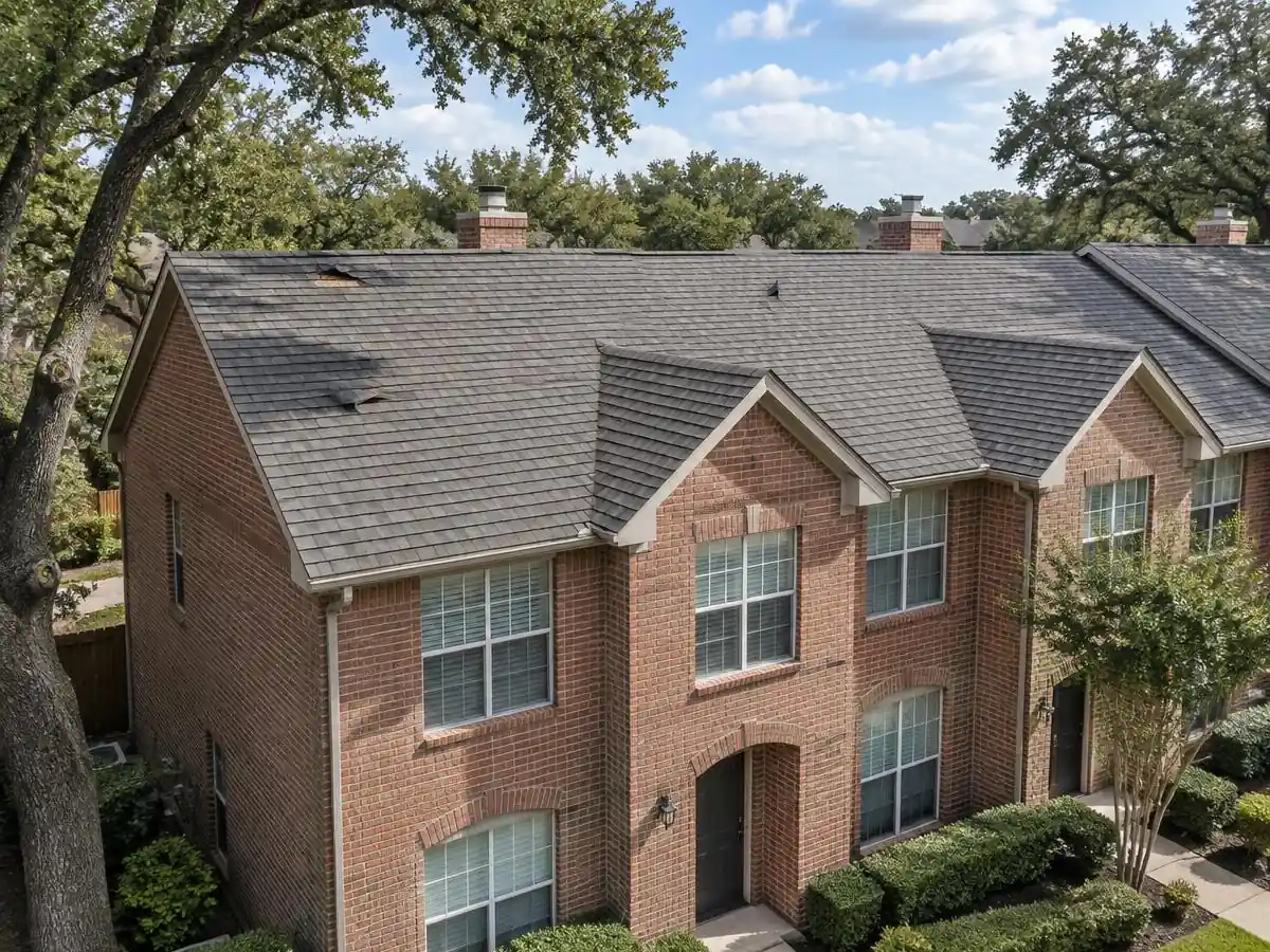 Storm-worn shingle roof on a townhome in Addison, TX