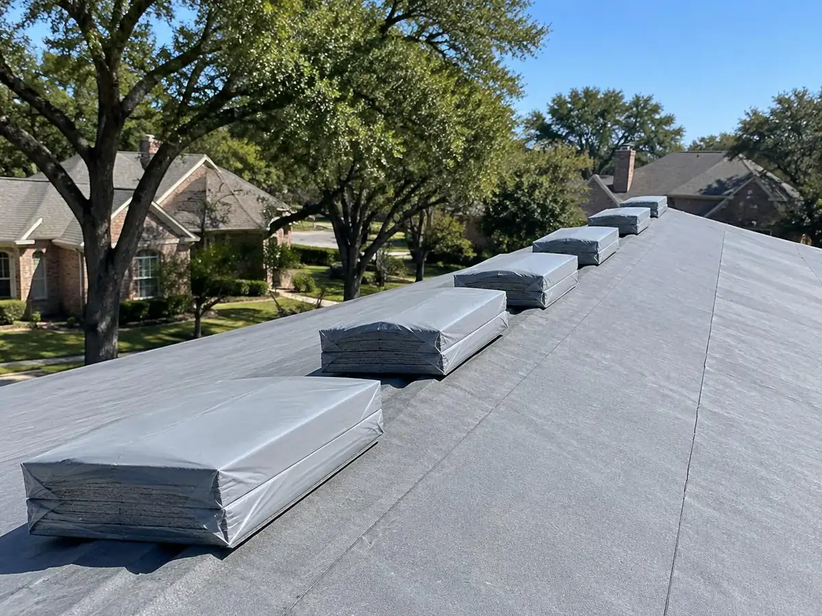 Architectural shingle bundles staged on a roof before installation in Farmers Branch, TX