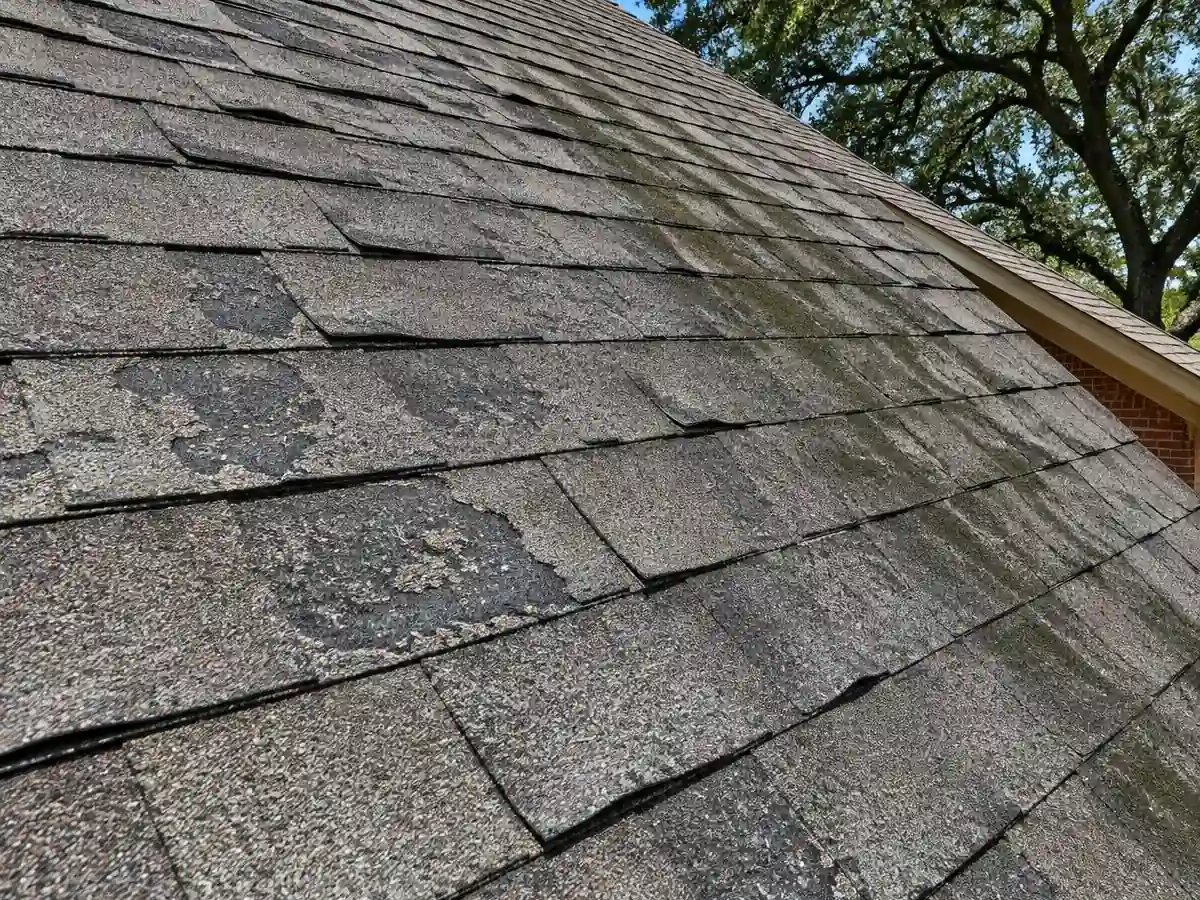 Curling and worn shingles that need attention on a home in Farmers Branch, TX