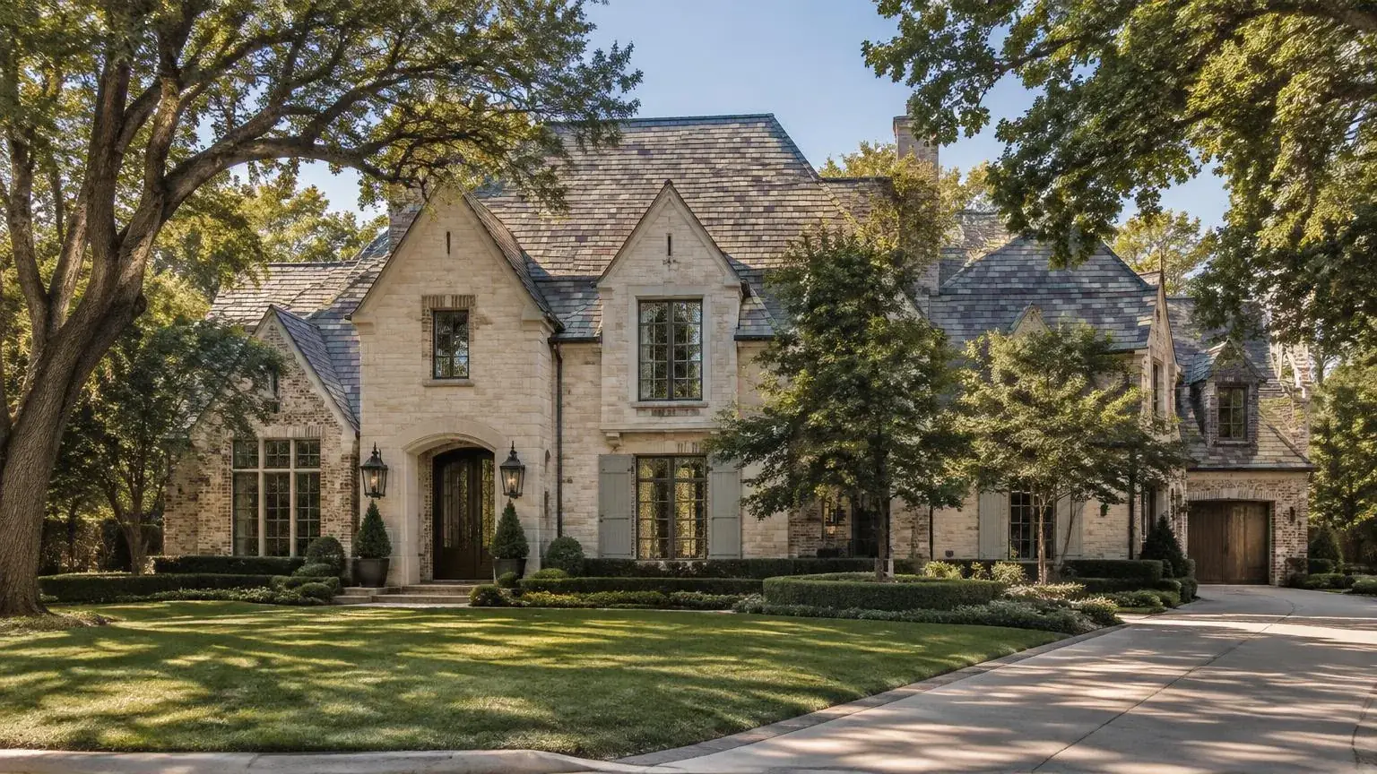 Finished natural slate roof on a stately brick home with mature trees in Preston Hollow, Dallas