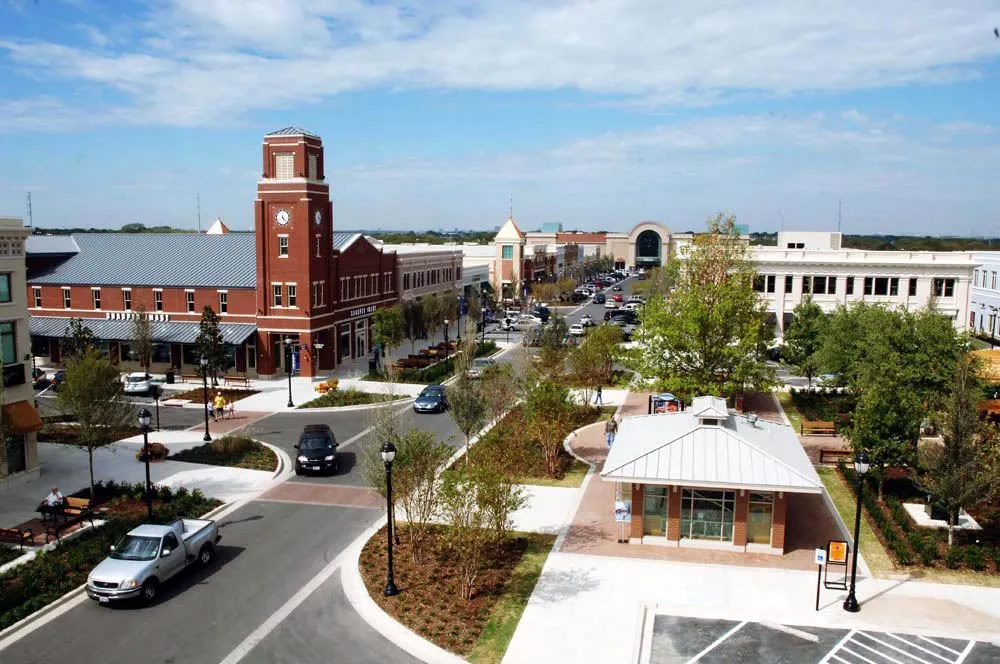 Garland Texas historic downtown plaza with red brick clock tower and circular courtyard, representing the heart of the community served by Under One Roof roofing and home services