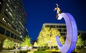 Richardson Texas modern cityscape at night featuring illuminated public art sculpture and contemporary buildings representing the innovative community served by Under One Roof home services