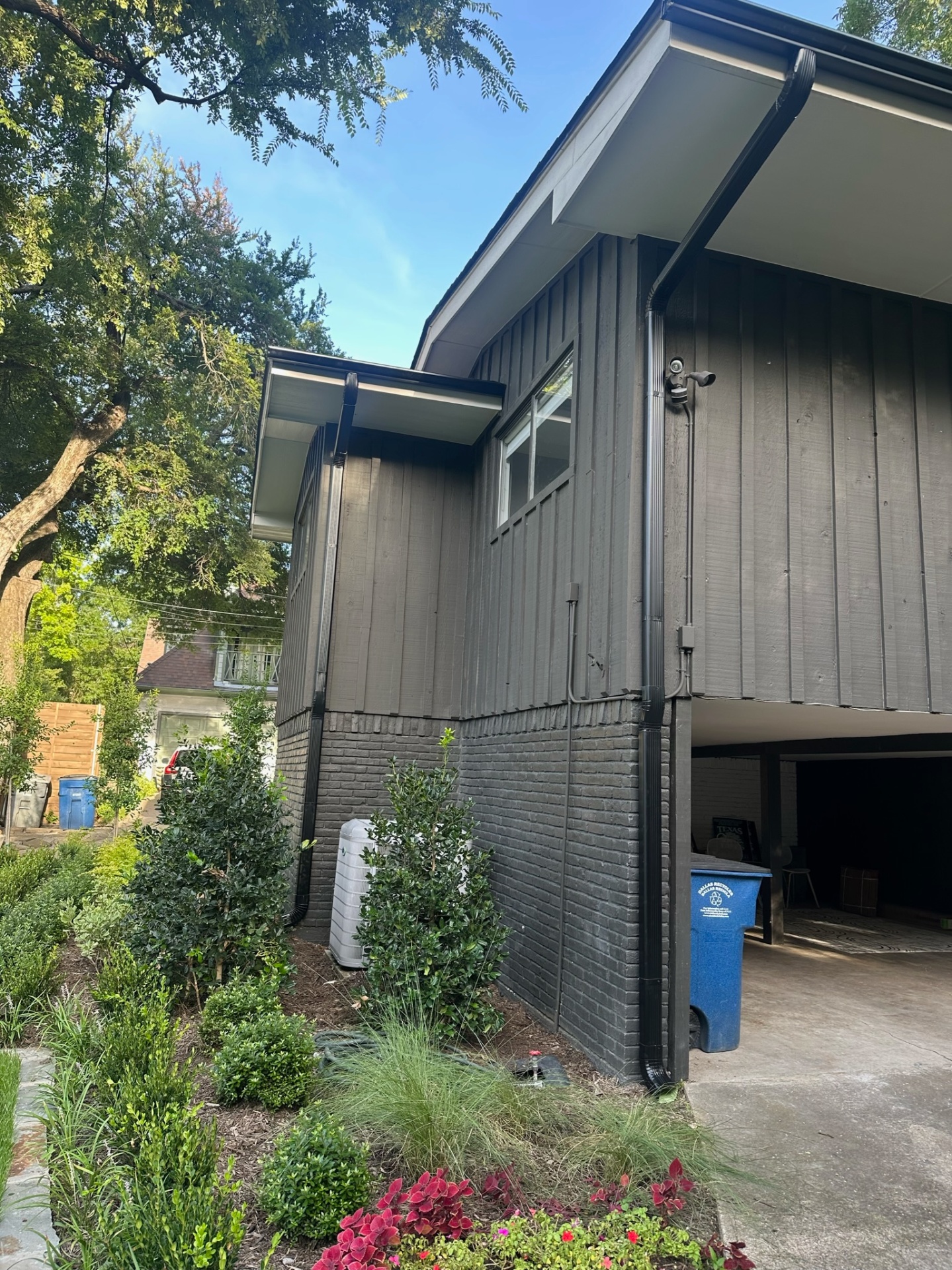 Beautiful home showing professional gutter system with mixed siding and brick materials by Under One Roof