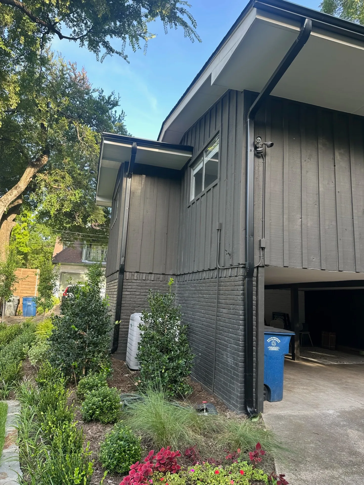 Beautiful home showing professional gutter system with mixed siding and brick materials by Under One Roof