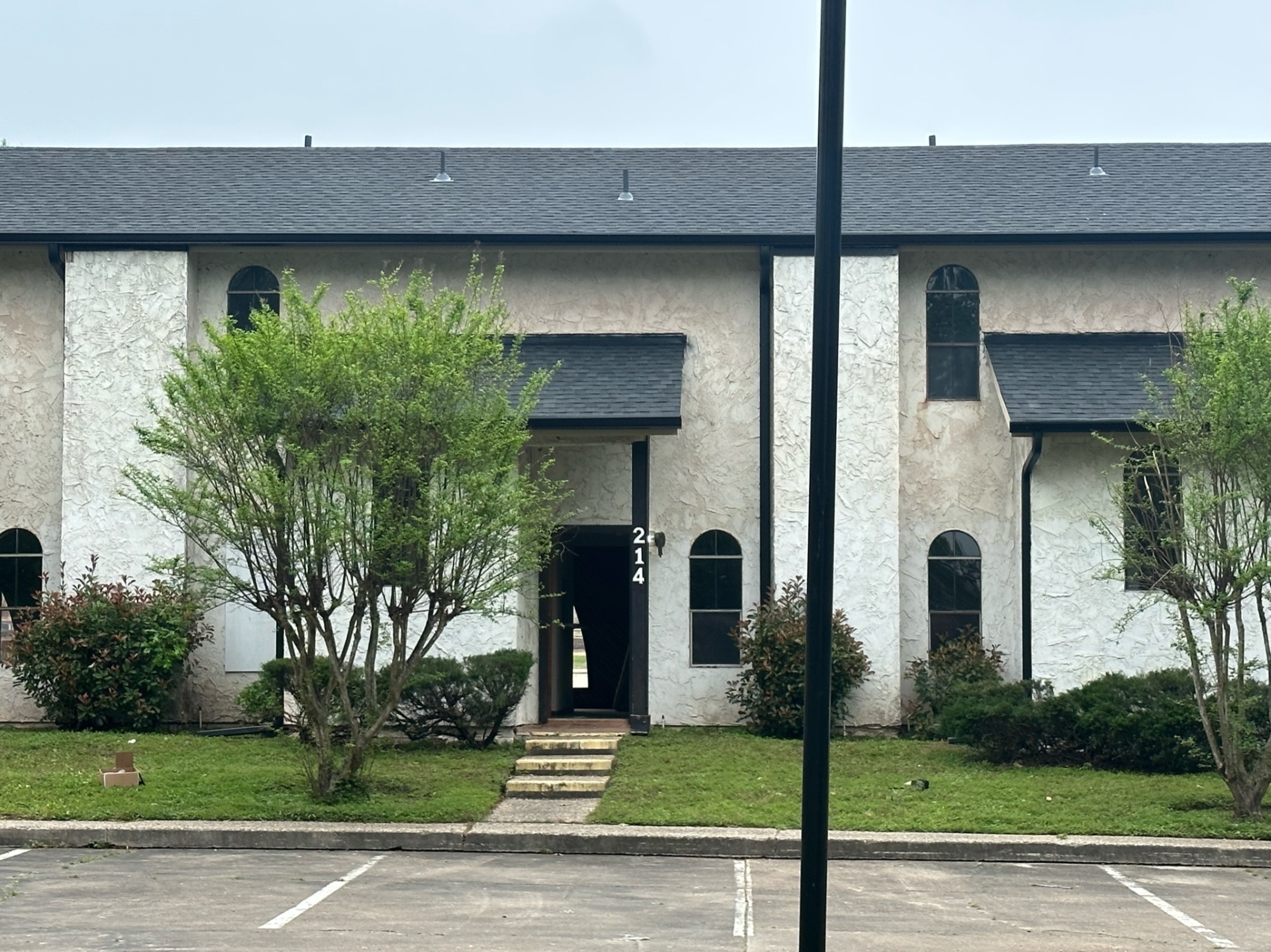 Completed multi-unit residential building with professional gray shingle roofing installation in Dallas, showcasing quality craftsmanship on townhouse complex
