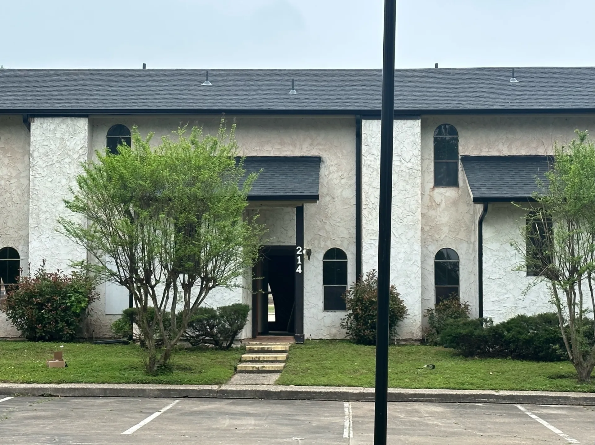 Completed multi-unit residential building with professional gray shingle roofing installation in Dallas, showcasing quality craftsmanship on townhouse complex