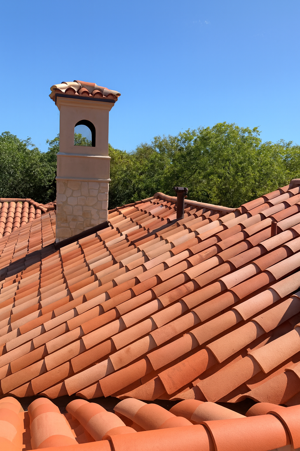 Beautifully restored clay tile roof in Dallas with rich terracotta color