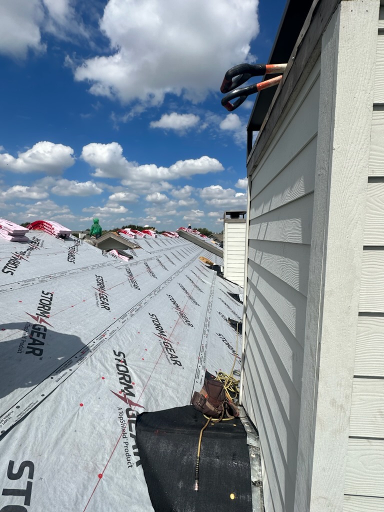 Multi-unit residential roofing and siding project in Dallas area, professional installation of underlayment on townhouse development with white siding