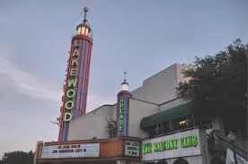 Historic Lakewood Theater in Dallas with classic neon marquee sign at dusk, representing the cultural heart of the Lakewood neighborhood served by Under One Roof home services