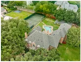 Aerial view of shingle roof installation on Southlake estate with pool and tennis court